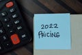 2022 Pricing write on sticky notes isolated on Wooden Table