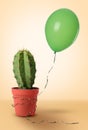 Prickly cactus and green balloon on beige background Royalty Free Stock Photo