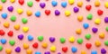Pride banner with rainbow colored hearts on a pink background and copy space for LGBTQIA+ Pride month and love diversity