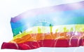 Colorful LGBT flag blows in the breez over crowd