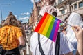 Pride flag in human hand on a pride parade