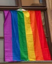 Pride of the LGBT rainbow flag in the city of Bratislava. View of the window of a building with a rainbow flag Royalty Free Stock Photo
