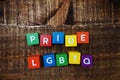 Pride and LGBTQ alphabet letters on wooden background