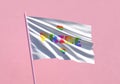 Pride rainbow word flag waving on a pink wall background for LGBTQIA+ Pride month, sexuality freedom, love diversity celebration
