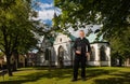 In front of the church in Horn-Bad Meinberg stands a priest in a black shirt with the Bible in his hand. Royalty Free Stock Photo