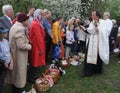 A priest blesses Easter baskets