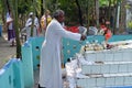 The priest blesses religious objects at the tomb of a Croatian missionary, Jesuit father Ante Gabric in Kumrokhali, India