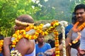 A priest bringing the holy water for the worship of Lord Shiva. the villagers enjoys the programme