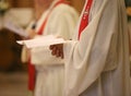 Priest with a cassock and hands joined in prayer