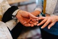 The priest changes the wedding rings on the fingers of the bride and groom. Wedding tradition and ritual. hands of young couples Royalty Free Stock Photo