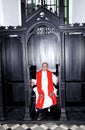 Priest in confession booth Royalty Free Stock Photo