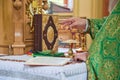 Priest consecrates bread during liturgy ceremony. Eastern Catholic Churches Royalty Free Stock Photo