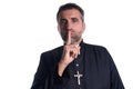 Priest with finger in lips as a silence