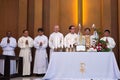 Priest giving beliver a Holy Communion