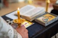 Priest hand holding burning candles in Church.