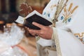 Priest holding bible. holy book in hands of a man, praying in church at wedding matrimony. traditional religious wedding ceremony Royalty Free Stock Photo