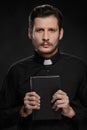 Priest holding Bible