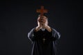 Priest holding cross of wood praying