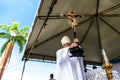 Priest is holding the image of Jesus on the cross on the traditional first Friday of 2023