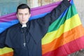 Priest holding the rainbow flag Royalty Free Stock Photo