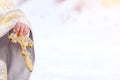 Priest holds golden cross in his hands. Copy space