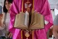 The priest holds the missal, Catholic church in Chunakhali, India