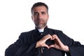 Priest man doing a heart shape with fingers