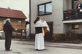 Priest with mask with eucharistic adoration on Easter sunday in village Martincek, Slovakia Royalty Free Stock Photo