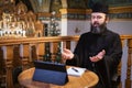 . Priest online. An Orthodox priest is recording a video for his blog. Preaching during a pandemic