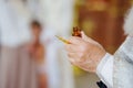 The priest performs chrismation at the sacrament of baptism. Royalty Free Stock Photo