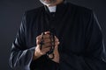 Priest praying hands with rosary beads Royalty Free Stock Photo