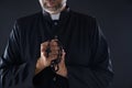 Priest praying hands with rosary beads Royalty Free Stock Photo