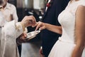 Priest putting on golden wedding rings on bride hand in church d