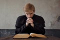 Priest read the Bible. Handsome young catholic priest praying to God Royalty Free Stock Photo