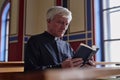 Priest reading Bible during ceremony Royalty Free Stock Photo