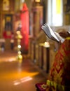 Priest reading Bible in Orthodox church interior Royalty Free Stock Photo