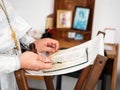 The priest reads the Bible in the Church. Bible and Church oil in the hands of the priest, close-up. The rite of baptism or