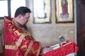 The priest reads a prayer at baptism