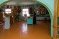 The priest reads a prayer in front of the altar in the interior of the village Russian church