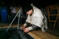 A priest of the Russian Orthodox Church reads prayers in honor of the baptism of the Lord Royalty Free Stock Photo