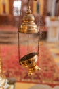 A priest`s censer hanging in the Orthodox Church. Copper incense with burning coal inside Royalty Free Stock Photo