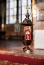 A priest`s censer hangs on an old wall in the Orthodox Church. Copper incense with burning coal inside. Service in the concept of Royalty Free Stock Photo