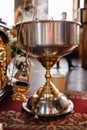 A priest`s censer hangs on an old wall in the Orthodox Church. Copper incense with burning coal inside. Service in the concept of Royalty Free Stock Photo