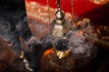 A priest`s censer hangs on an old wall in the Orthodox Church. Copper incense with burning coal inside. Service in the concept of Royalty Free Stock Photo