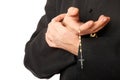 Priest's hands with rosary