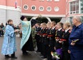 The priest sprinkles with holy water the cadet before academic year.