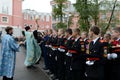 The priest sprinkles with holy water the cadet before academic year.