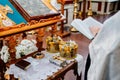 Priest is standing near Lectern.high table with sloping top for liturgical books