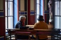 Priest talking to visitor during ministration