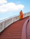 Priest walking up stairs at Wat Saket